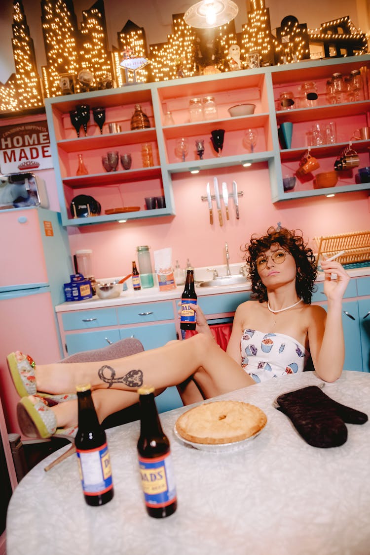 Woman Smoking And Drinking In Retro Kitchen