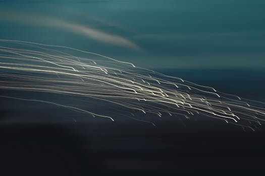 Dynamic abstract light trails create an artistic motion effect against a dark backdrop.