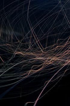 An artistic display of colorful light trails weaving across a dark backdrop, ideal for modern designs.