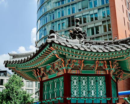 Colorful Korean pavilion contrasting with modern architecture in Berlin, Germany.