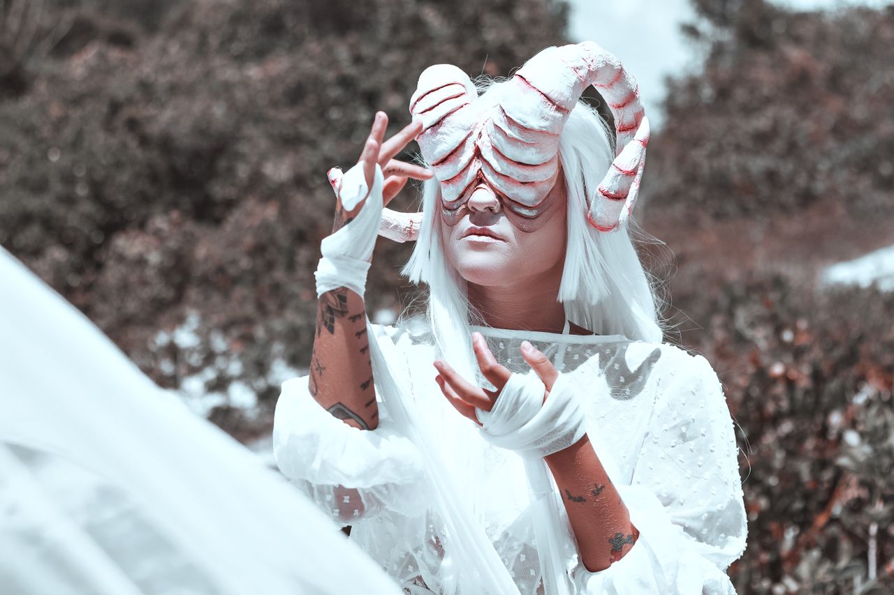 surreal fantasy portrait featuring a person in a horned costume with a