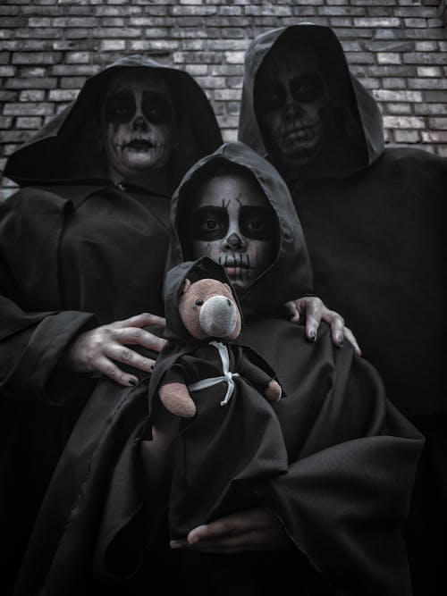 Free People Wearing Black Cloak with Skull Face Paints Stock Photo