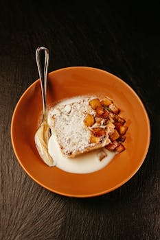 A mouthwatering slice of coconut cake with diced pineapple served on a plate.