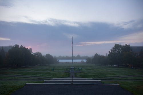 Free stock photo of american flag, early sunrise, field of grass