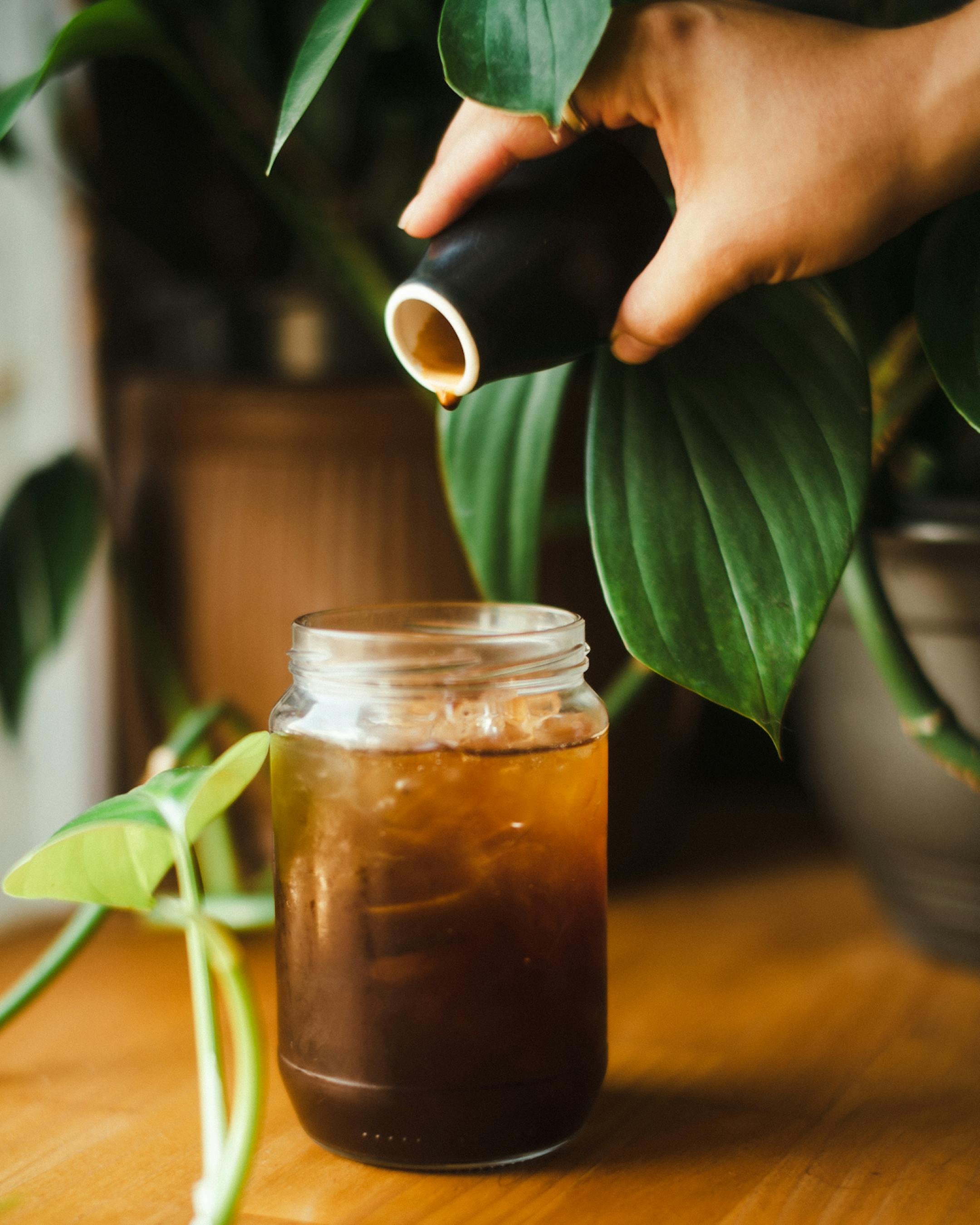 Cold brew coffee poured into a jar and glass with ice
