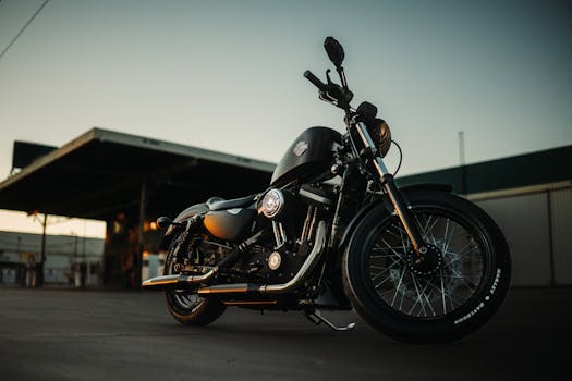 A sleek black motorcycle parked outdoors during sunset, capturing an adventurous vibe.