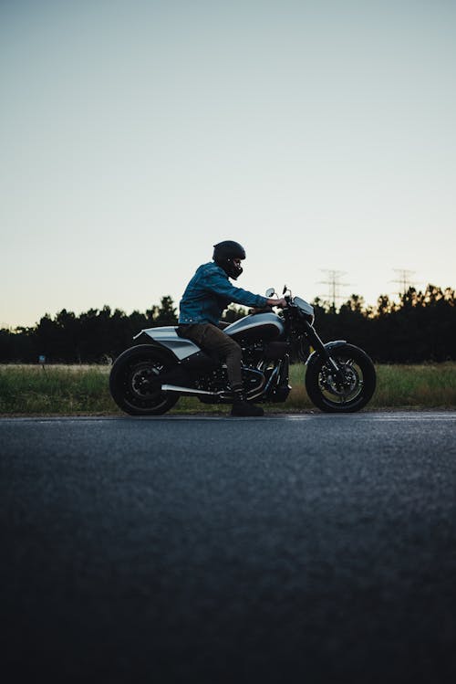 Motorcyclist Posing on Road