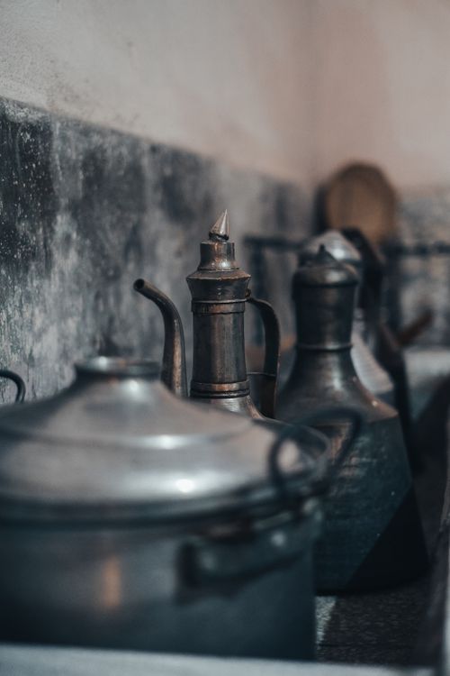 Free A nostalgic still life of retro metal kettles and cookware in muted lighting Stock Photo