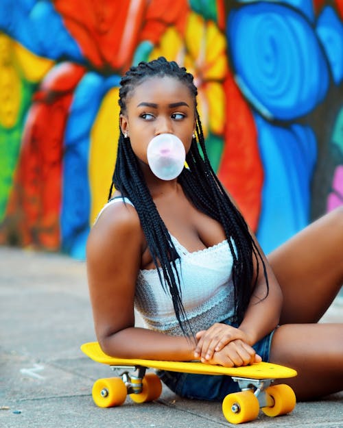 Young Girl with Dreadlocks Sitting with Skate 