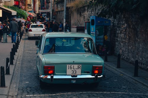 Old Fiat 125p on a Cobblestone Street in City 