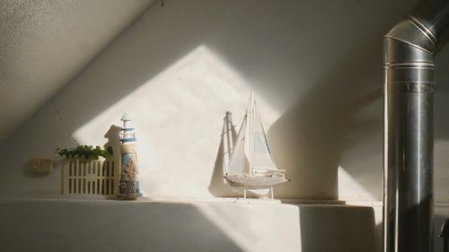 Free Cozy indoor scene featuring a lighthouse and sailboat model in natural light. Stock Photo