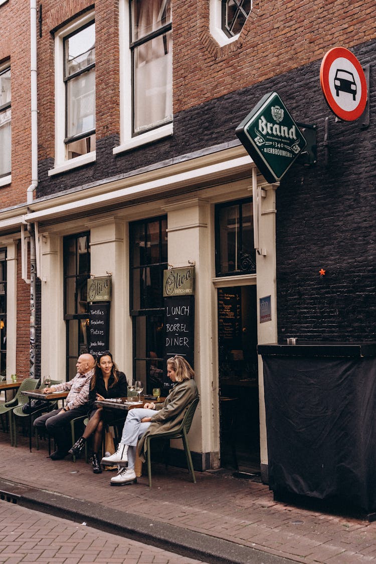 People Sitting Outside A Restaurant