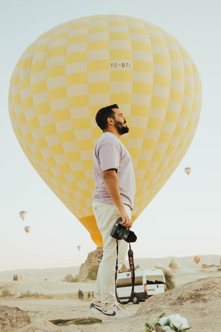 Man In T-shirt And Balloon Behind