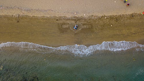 Aerial Photography of a Romantic Couple on the Beach