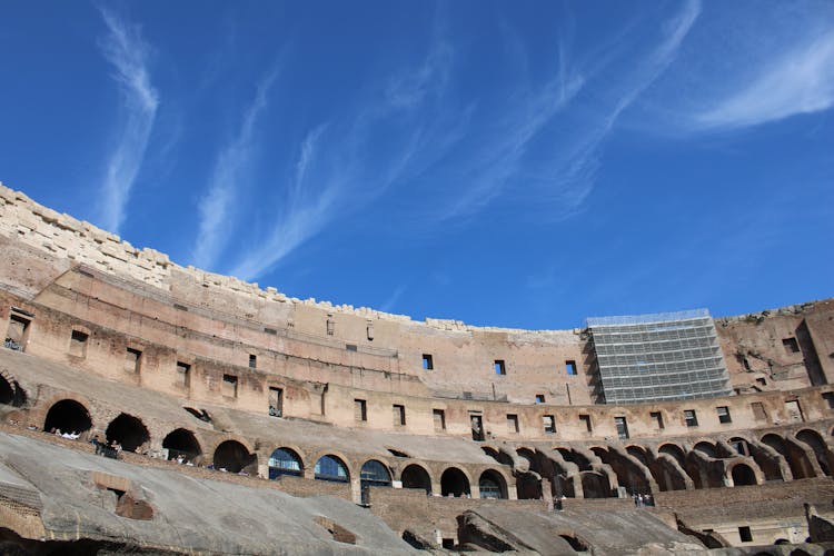 Upper Tier Of The Colosseum In Rome, Italy Under Blue Sky