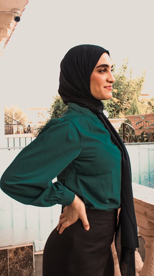 A Woman Wearing Black Hijab and Green Long Sleeves