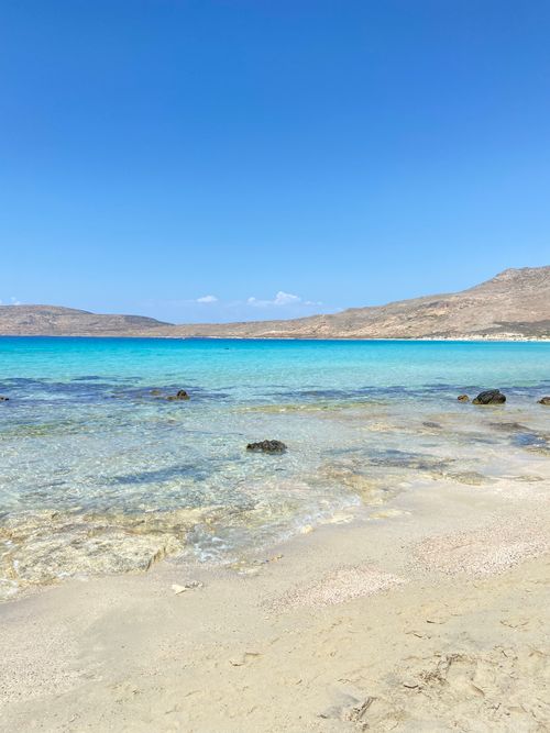 Free Tranquil beach and turquoise waters of Elafonisos, Greece, under a clear blue sky. Stock Photo