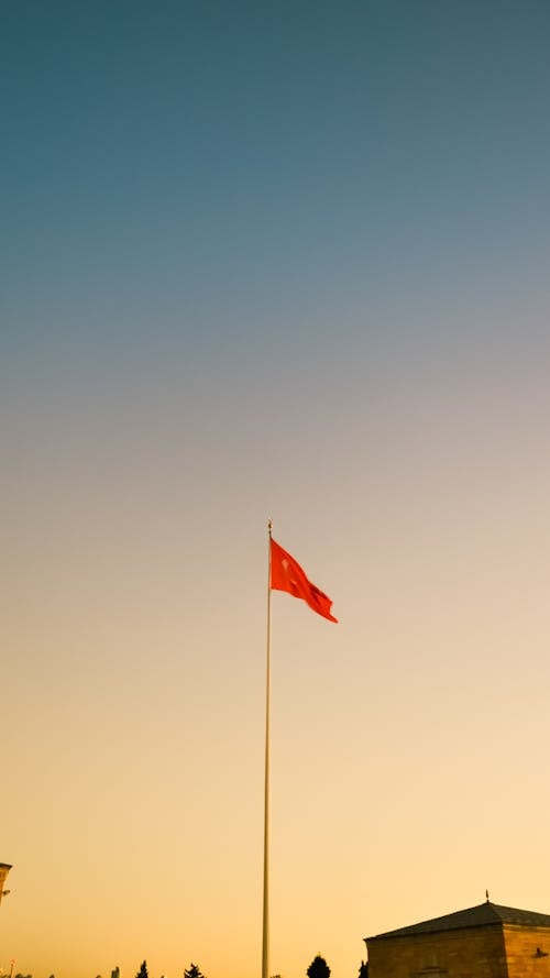 Red Flag of Turkey on Pole during Sunset