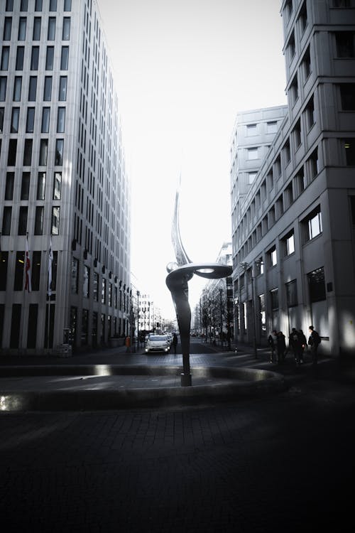 Free Spiral Shaped Fountain Statue Between Two High-rise Buildings Stock Photo