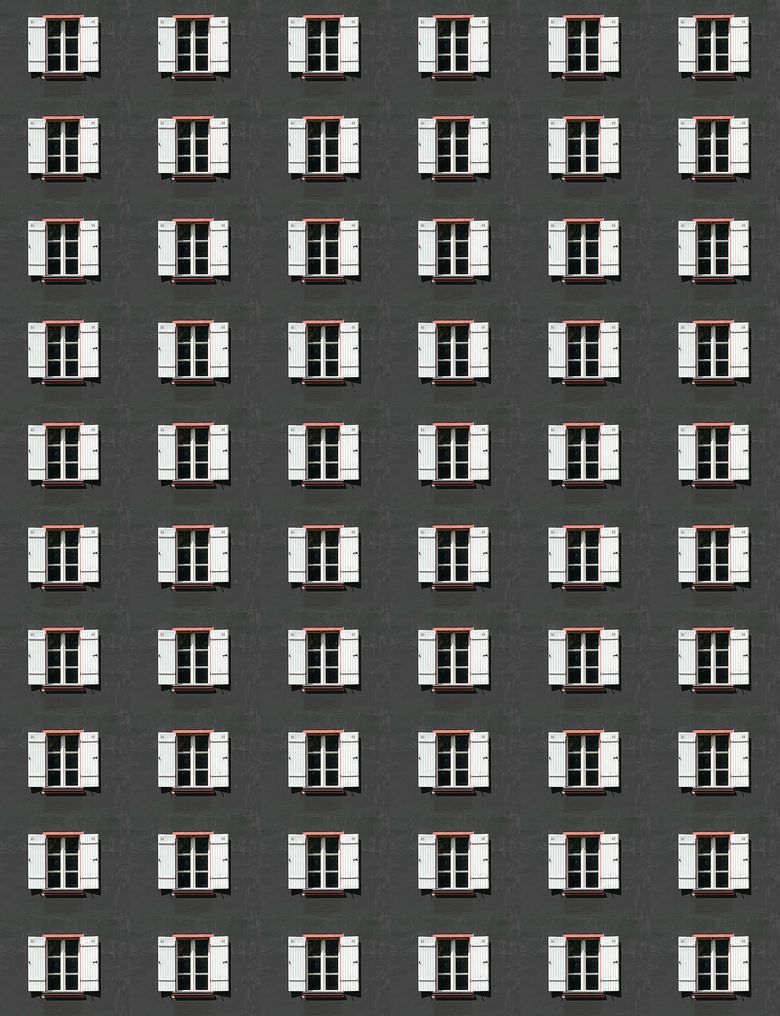 A striking image of a Berlin building's facade featuring a grid pattern of symmetrical windows.