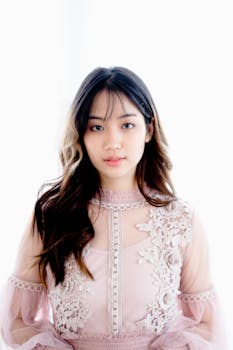 Beautiful portrait of a woman in a pink lace dress with floral design