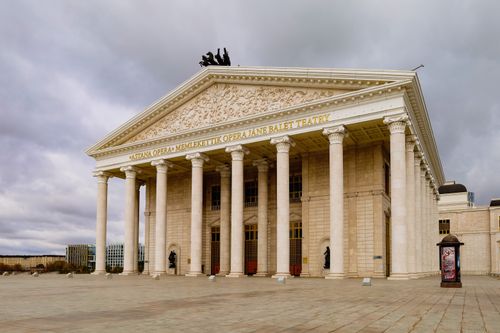 Free Astana Opera House facade with columns under a moody sky, showcasing neoclassical architecture. Stock Photo