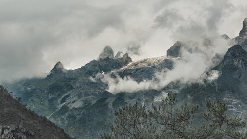 Gray Rocky Mountains Covered with Clouds