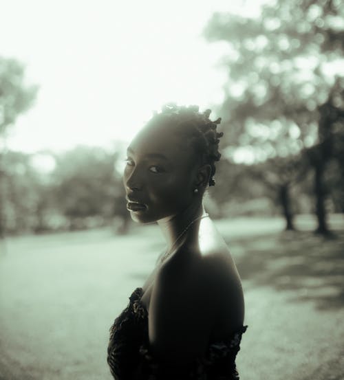 Woman in Off Shoulder Dress Standing in the Park