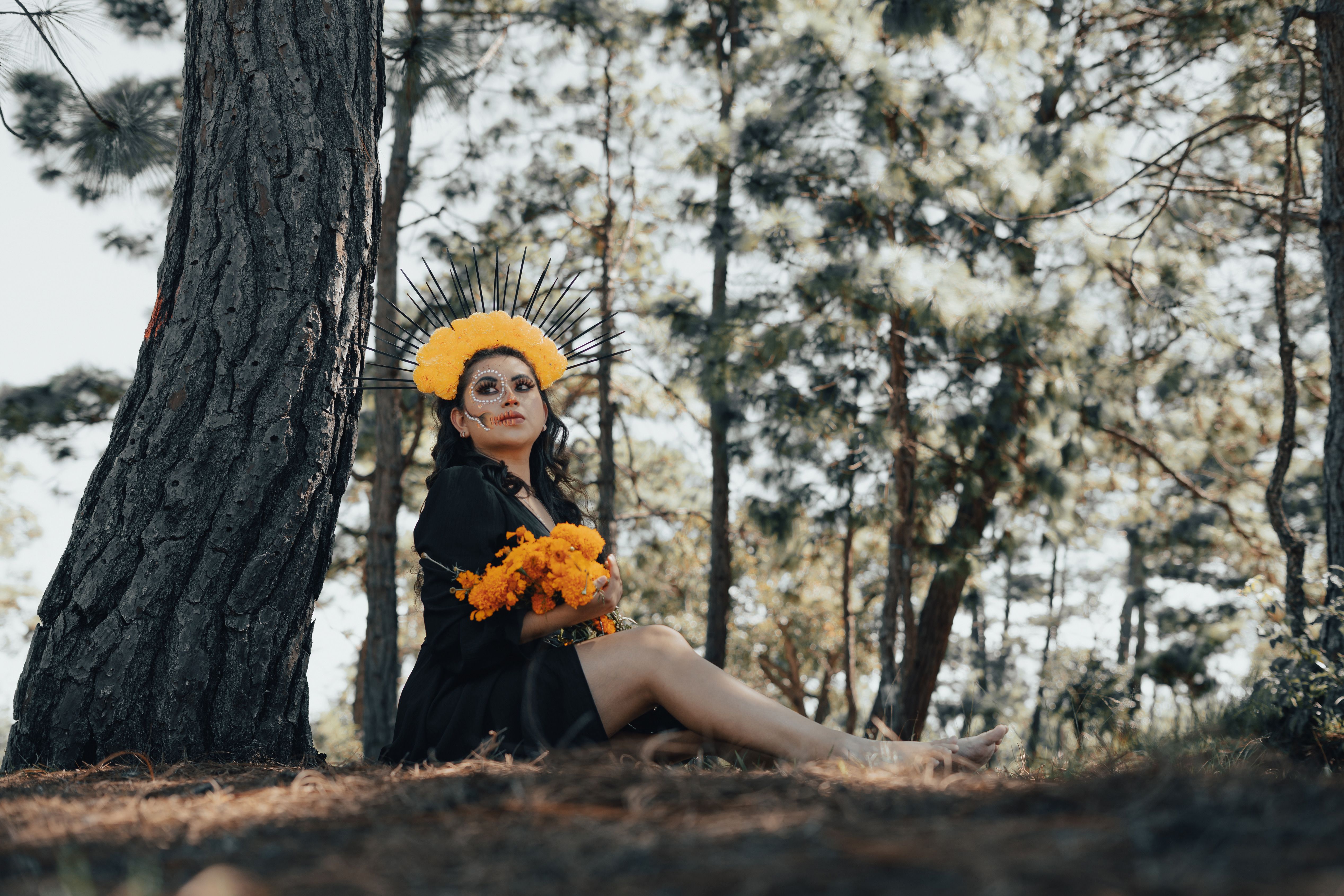 Woman in Black Dress Holding Flowers · Free Stock Photo