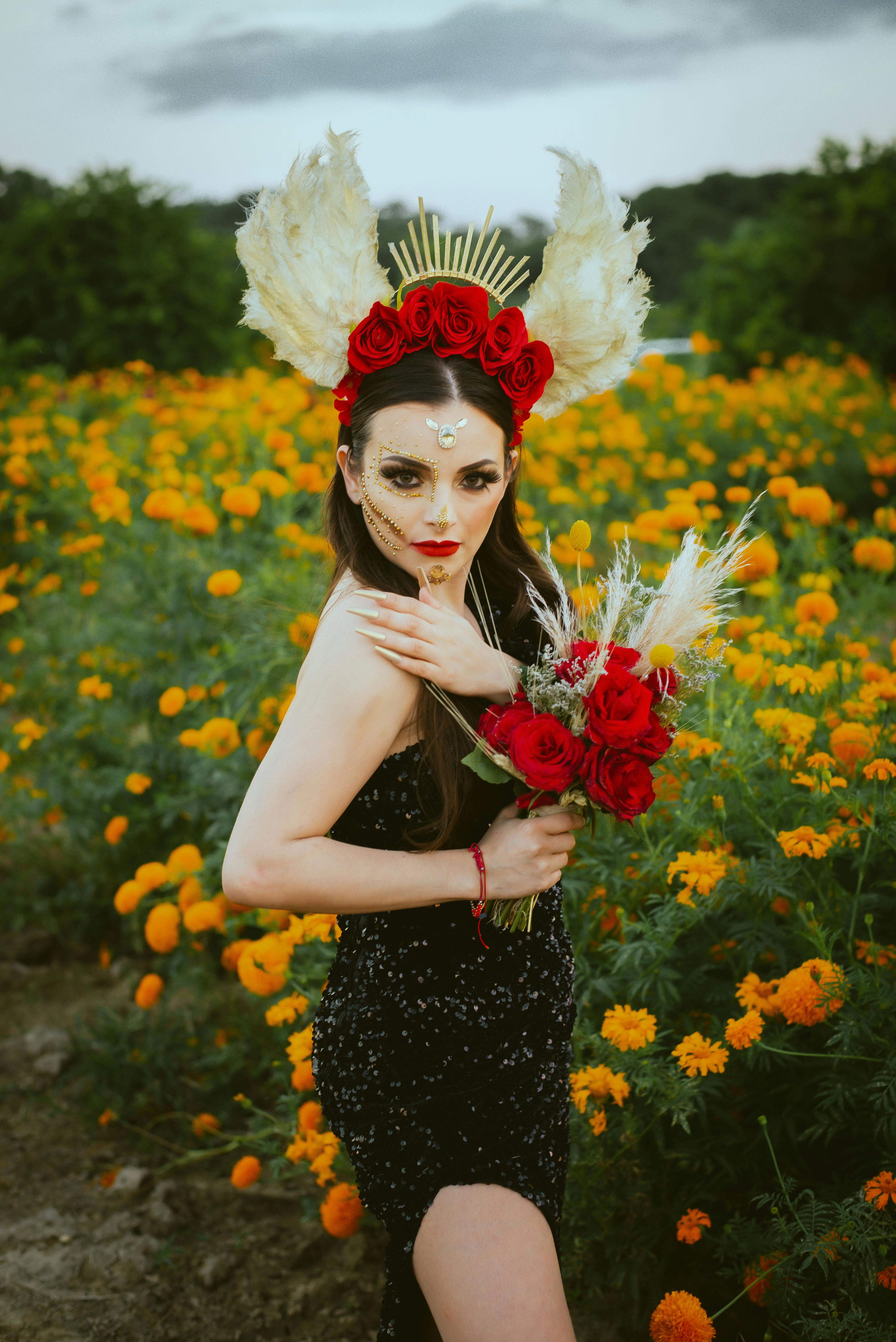 woman in black dress holding flower bouquet