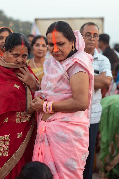 Women in Traditional Clothing Standing among People