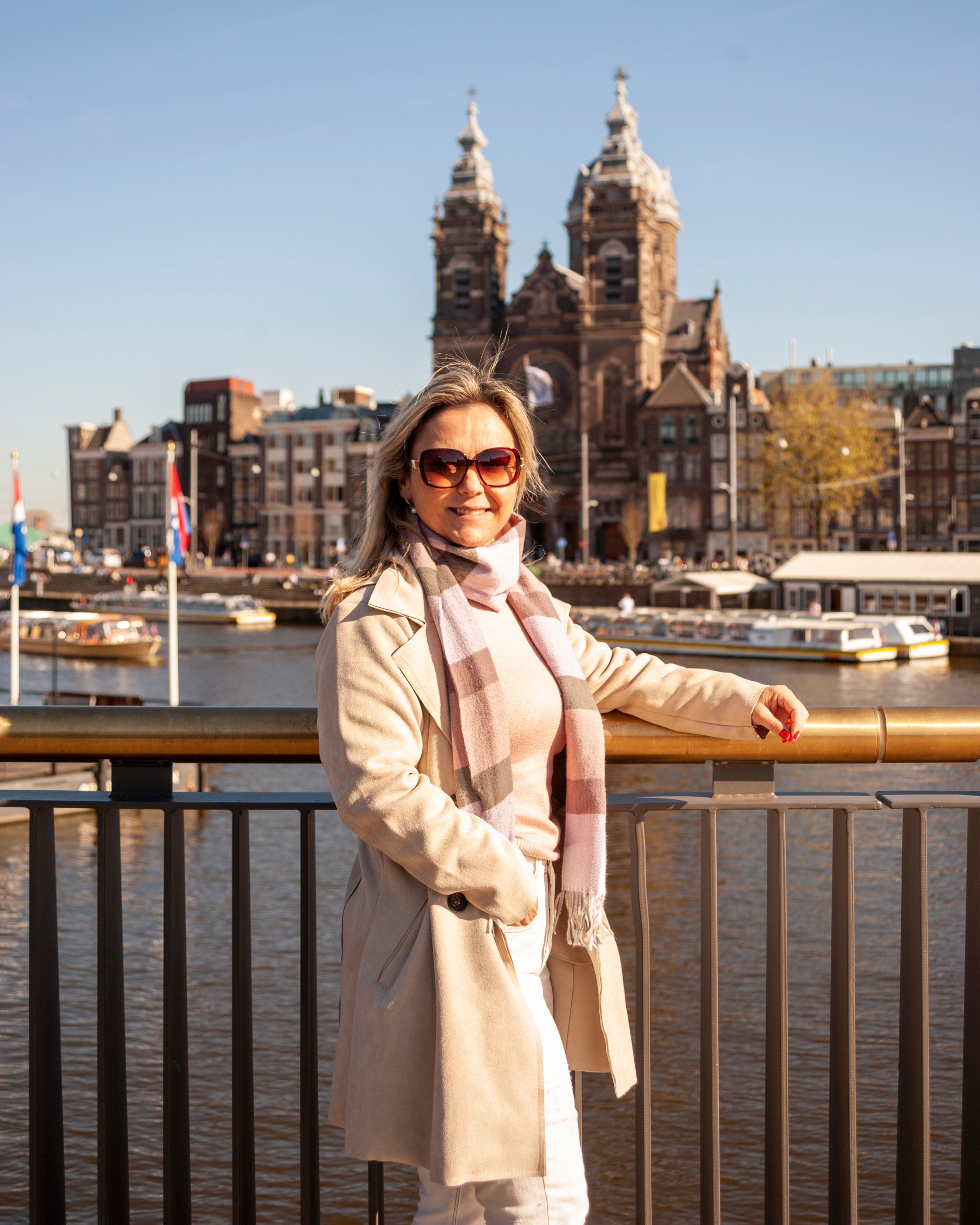 Woman in Beige Coat Standing Near Railings · Free Stock Photo