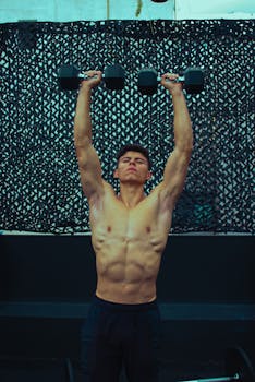 Muscular adult lifting dumbbells in an indoor gym setting during a workout session.