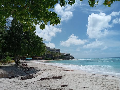 Idyllic beach scene in Bridgetown, Barbados with clear skies and turquoise sea.