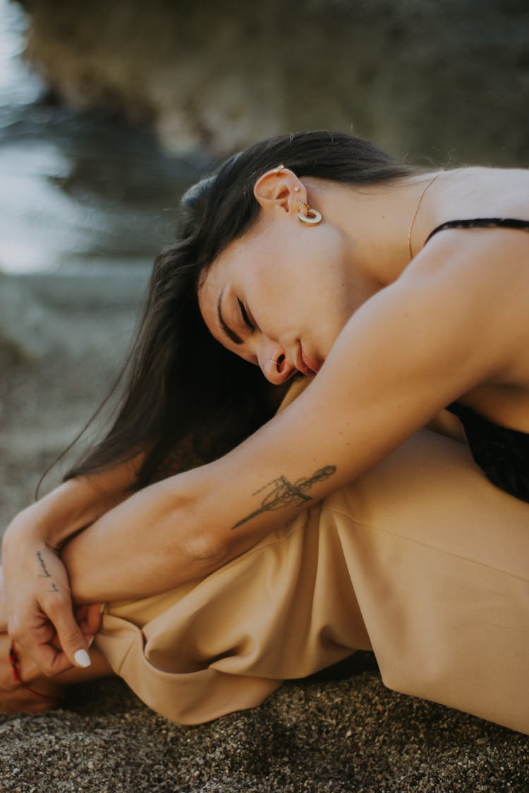 Woman Resting Head On Her Knees 