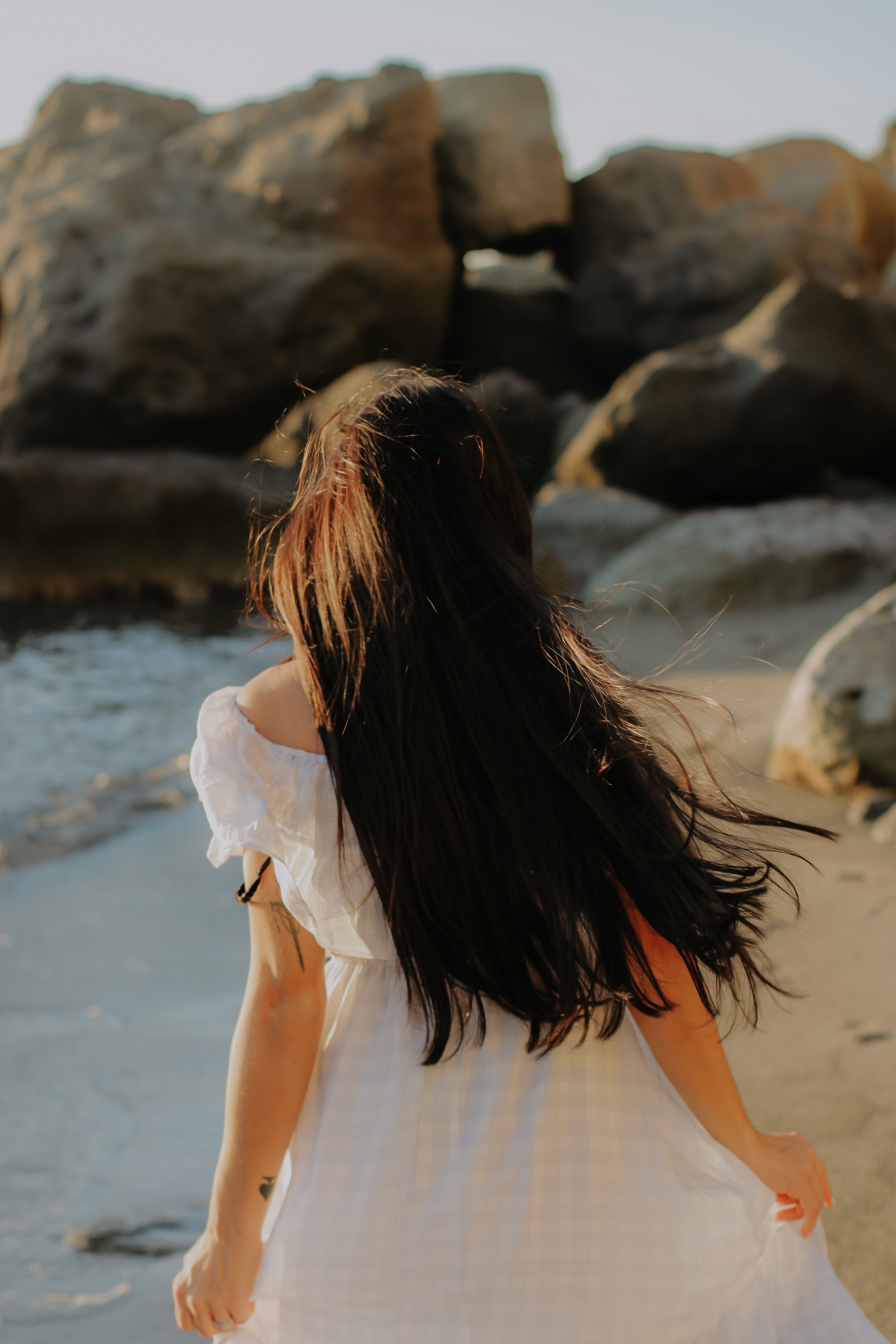 A Woman Wearing a White Dress at the Beach · Free Stock Photo