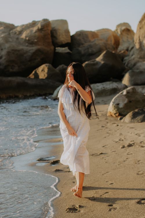 A Woman in White Dress Walking on the Shore Free Stock Photo A Woman in White Dress Walking on the Shore Free Stock Photo