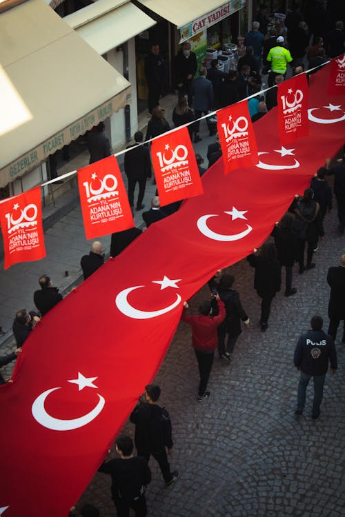 High Angle Shot of People Holding a Turkish Flag Banner