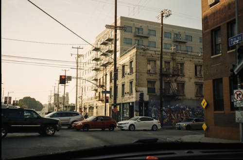 Cars Parked on Side of Road Near Buildings