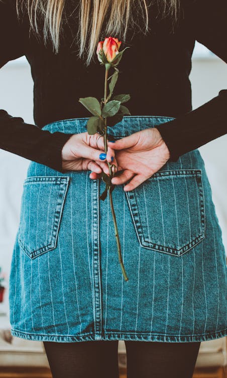 Free Woman Holding Flower On Her Back Stock Photo