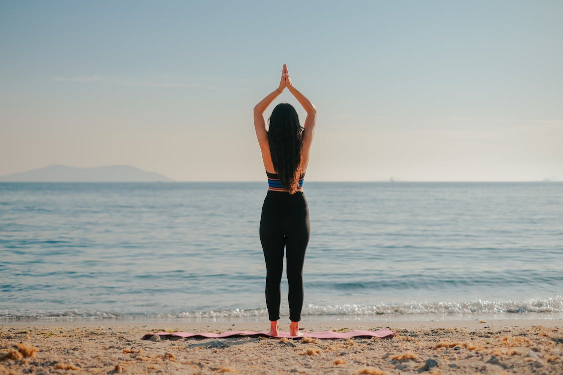 Trying Some Yoga Poses at the Beach Stock Image - Image of