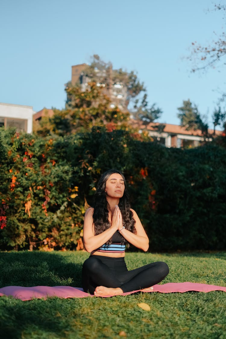 Woman Meditating On Mat