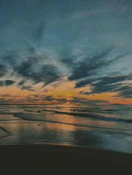 Peaceful seascape at sunset with vibrant colors and gentle waves, perfect for relaxation.