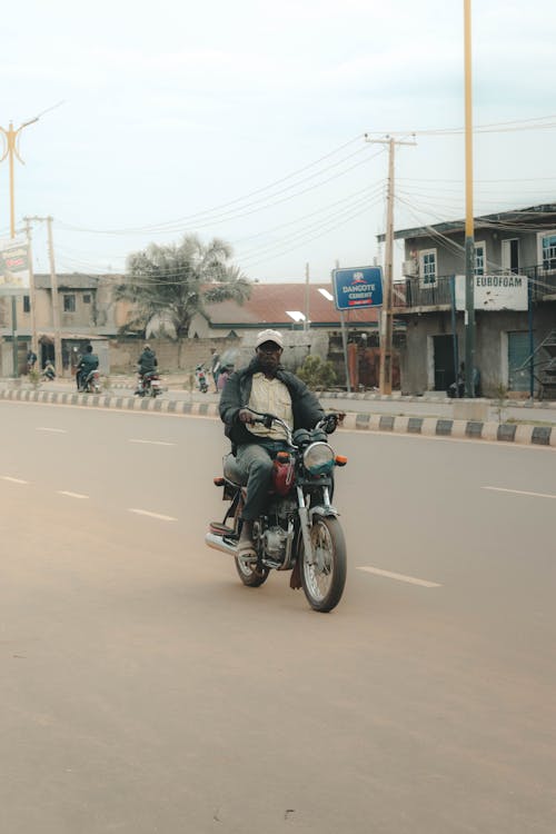 A Man Driving Black Motorcycle