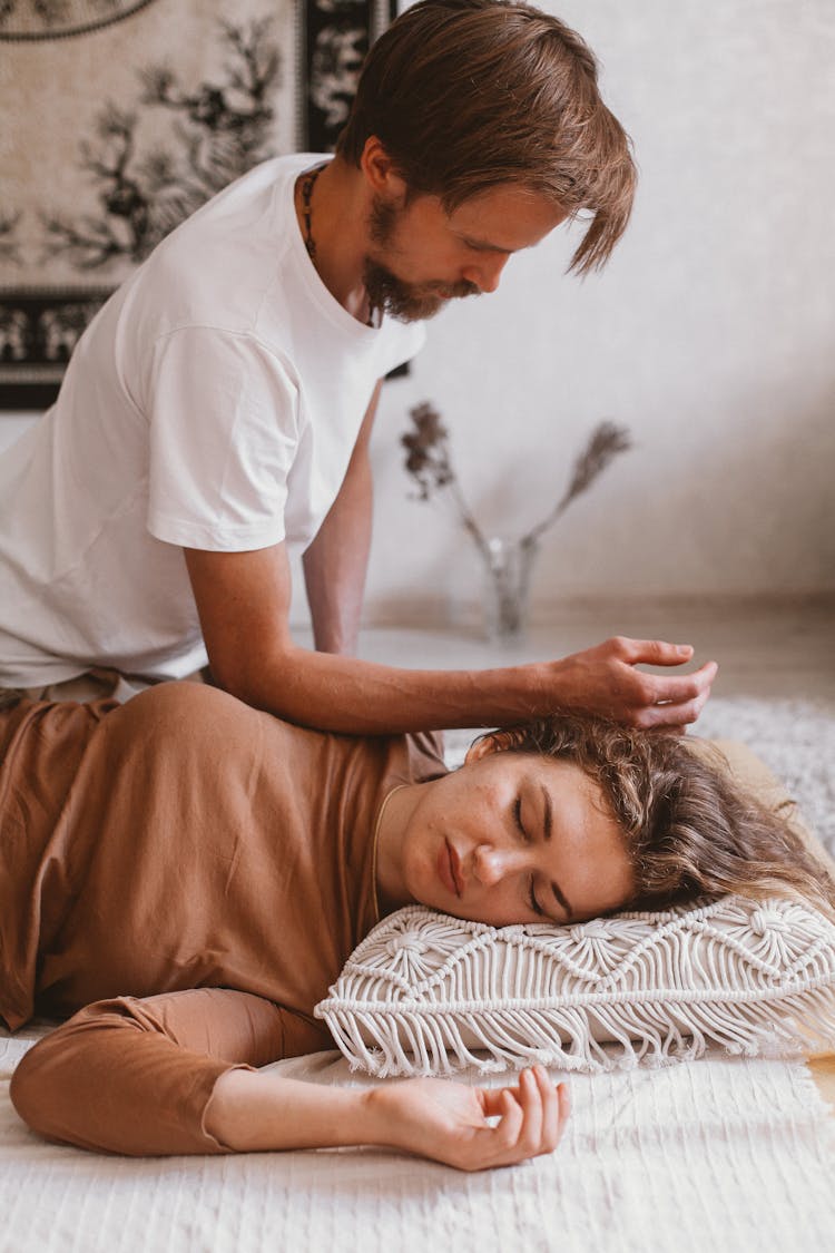 Man Sitting On Floor And Woman Sleeping