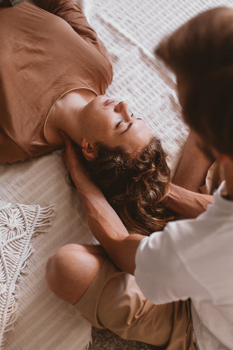 Man Holding Woman Head On Floor