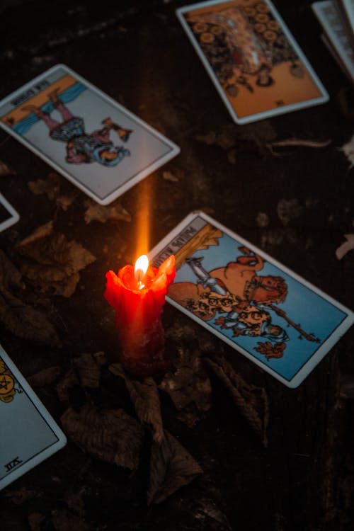 Burning Candle Beside the Tarot Cards