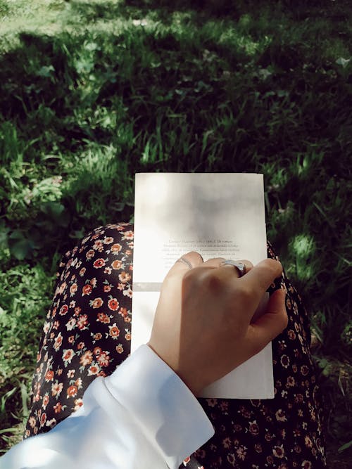 A Person Holding White Book