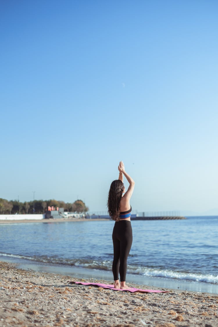 Woman On Mat On Beach