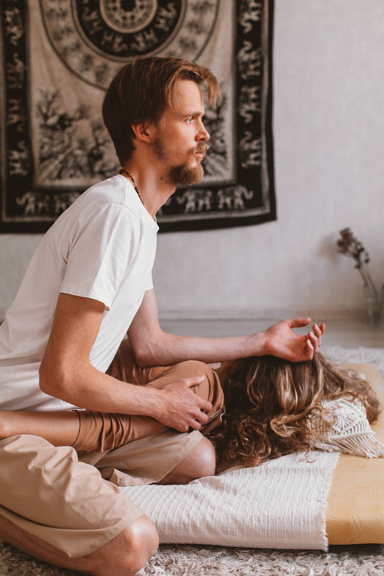 Man Sitting With Woman On Floor